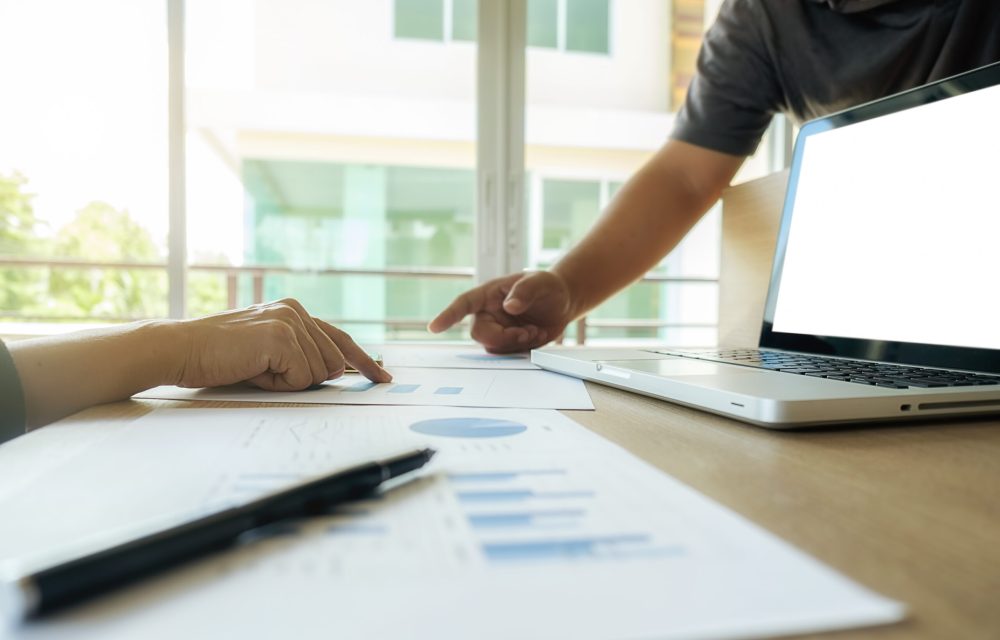 Asia business people discussing the charts and graphs showing the results of their successful teamwork.Vintage tone Retro filter effect,soft focus,low light.(selective focus)